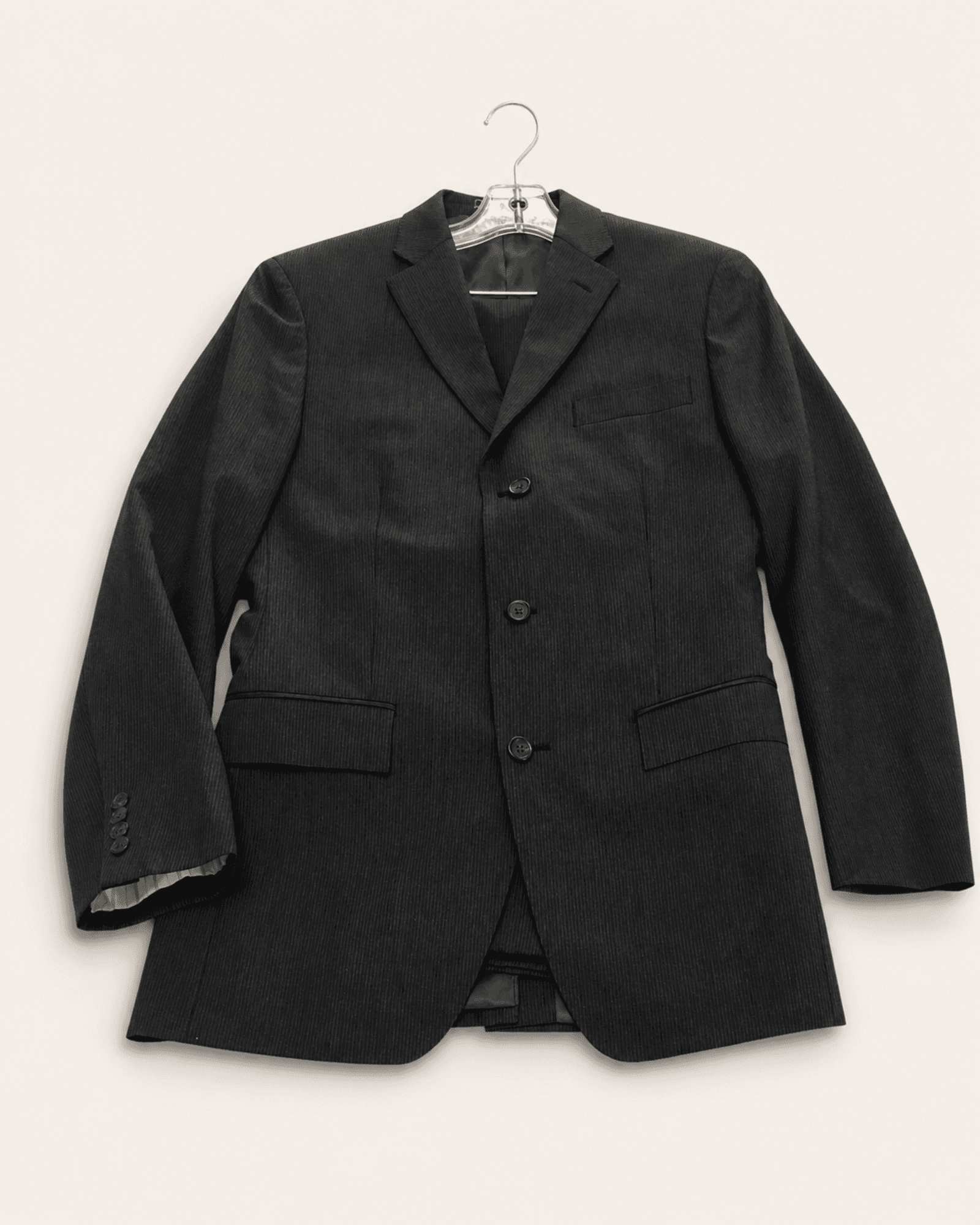 Preview of a dark gray fine-striped Lauren Ralph Lauren suit jacket with matching trousers partly visible